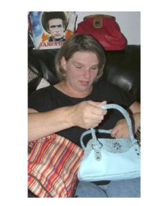 Lisa Athey shows just a sampling of the handbags she offers through Perfectly Purses and More.