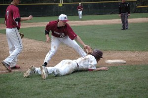 Enumclaw High’s Cooper Wicks applies a tag at third
