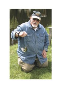 Dick Kirbride shows a rainbow trout he caught during a Father’s Day fishing trip at Jim’s U Fish at Old McDebbie’s Farm in Spanaway June 18. Staci Guirsch and Phil DeLeo