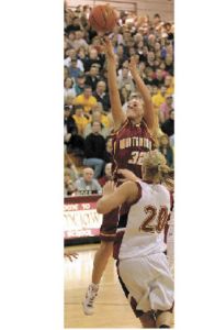 Megan McKune puts up a shot over Jessalyn Clark.