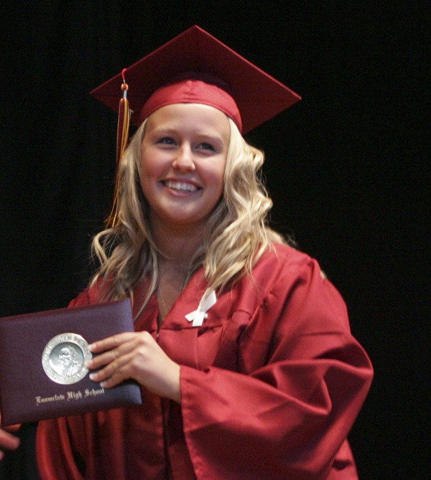 Enumclaw High graduate Julie Curtin accepting her diploma at the White River Amphitheatre Monday during commencement ceremonies.
