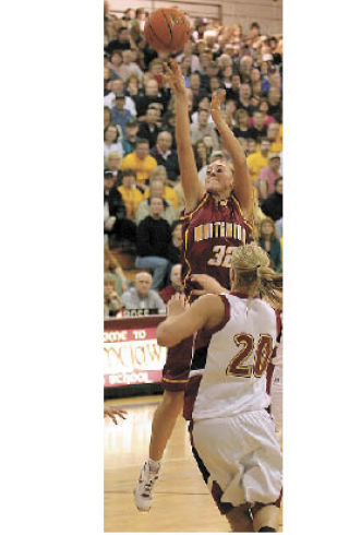 Megan McKune puts up a shot over Jessalyn Clark.