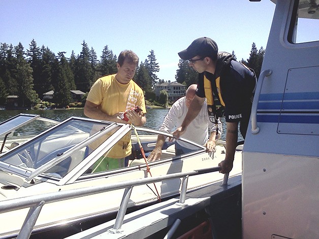 Officer Eric Alfano checks a fire extinguisher during a safety inspection stop.