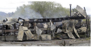 Smoke continues to rise after firefighters spent approximately two hours putting out an early-morning fire at an abandoned barn in Sumner.