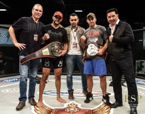 Justin Harrington and Tyson Cunningham display their belts with their coaches.