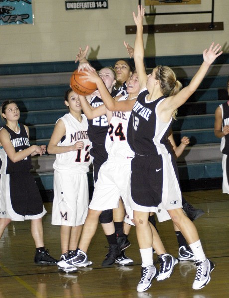 Bonney Lake's Cheyann Clark (22) and Emily McCoy (12) defend against Monroe's Kierra Wilkins in the Dec. 30 finals of the Bonney Lake Holiday Classic.