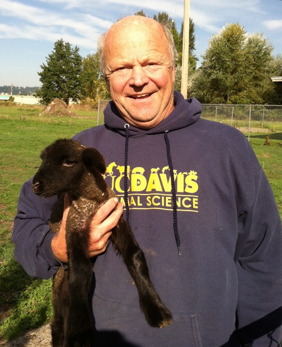 Greg Pile stands proud with one of the may farm animals he takes care of.