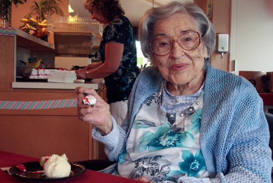 Genyss Vaughan eating cake and ice cream at Stafford Suites for her 100th birthday