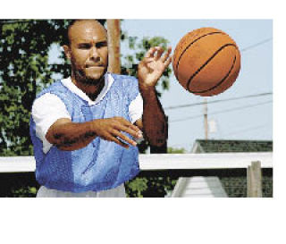 Derek Mohn dishes a pass during Saturday’s action. The 3-on-3 tournament in Buckley aimed to raise money for additional lighting on the public courts.
