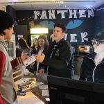 Bonney Lake High School DECA President David Azure hand students stickers and flyers advertising their Death by Chocolate event on April 8, 2017. Photo by Ray Still.