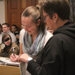 Audrey Crumb signing her certificate of service. Photo by Ray Still.