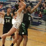 Enumclaw junior Madison Bosik goes up to the hoop against Kentwood guard Nicole Ajayi. Photo by Dennis Box.