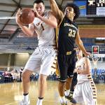 Kaden Anderson pulls down a rebound during Enumclaw High&rsquo;s tournament-opening victory over Inglemoor. Photo by Vince Miller