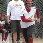 Enumclaw High&rsquo;s fastpitch coach Mike Eckhart encourages base runner Becca Fabris as she takes off third heading for home to score during a 2016 playoff game. Photo by Kevin Hanson.