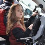 Caden Smith, a first-grader at Daniel Elementary, pretends to drive a police car. Photo by Heidi Sander.