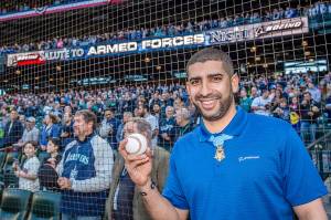 Flo Groberg, Boeing&rsquo;s director of veterans outreach and Medal of Honor recipient, prepares to throw out the ceremonial first pitch at the Mariners Salute to Armed Forces game, sponsored by Boeing.
