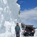 A Department of Transportation worker standing by a wall of snow after Chinook Pass was cleared today, June 9. Contributed photo