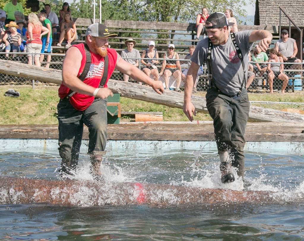 Darryl Dunford and Jake Frick compete in log rolling. Photo by Alicia Britschgi