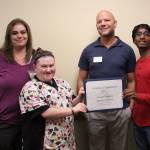 Tanishq Hessenaur, far right, and Bethany Helland, left, gives Mikey Allen and Melissa Martin a certificate of appreciation from Enumclaw High School&rsquo;s Transition Program. Photo by Ray Still
