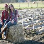 Ross and Venise Cunningham in front of their first garlic crop in 2013, when the first Goats and Garlic festival was held. Photo courtesy Laura Morceau