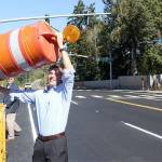 Pierce County councilman Dan Roach removes the &ldquo;last barrel&rdquo; to open up the new 198th Avenue and Rhodes Lake Road East intersection. Photo by Ray Still