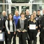 Ofc. Todd Green, Sgt. Tom Longtine, records clerk Jaime Amsbaugh, Det. Kyle Torgerson, admin assistant Louise Emry, Sgt. Rob Hoag, records clerk Heather Tower, Ofc. Tobie Johnston, Ofc. Eric Alfano, and Ofc. Buddy Mahlum. Photo by Ray Still