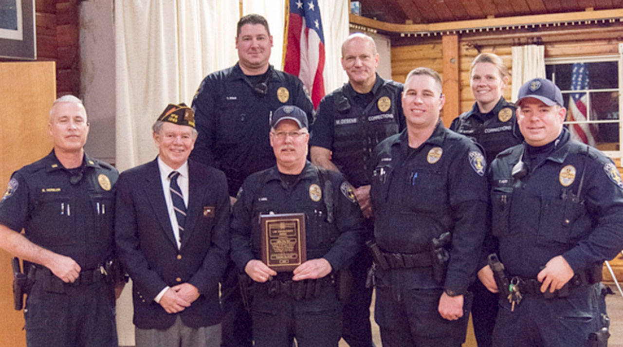 Police Officer Tony Abel shows his award; to his right are VFW Post Commander Derick Segurson and EPD Acting Chief Bob Huebler. Photo provided by VFW Post 1949