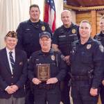 Police Officer Tony Abel shows his award; to his right are VFW Post Commander Derick Segurson and EPD Acting Chief Bob Huebler. Photo provided by VFW Post 1949