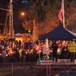 Despite the threat of rain and wind, hundreds turned out at Allan Yorke Park and lit candles in memory of the deceased. Photo by Ray Still