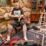 Without the use of his hands, Tim-Me has learned to use his feet for many daily tasks, including writing, typing, using a lighter and even playing the bass. Photo by Robert Lang/Robert Lang Studios