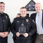 Bonney Lake Officer Joe Scott holding his Hit of the Year Award, with his former co-worker Sgt. Paul Ryan of the Monroe Police Department on his left and Stop Stick National Sales Director Adam Freeman on the right. Photo by Ray Still
