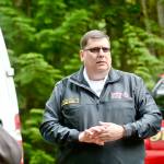 Brinnon Fire Chief Tim Manly speaks to reporters Monday about the fire that killed a family of five early Sunday morning. (Jesse Major/Peninsula Daily News)