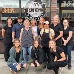 The crew at Anns Fudge gathered for a photo in front of the Cole Street shop. Owner Ann Smith is in stripes. Submitted photo