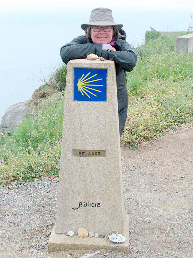 Becky Rush-Peet at the very start of her pilgrimage. The scallop shells at the bottom of the marker is a symbol of the Camino de Santiago. According to some stories, the ship carrying St. James body was lost at sea, but when it was found, it was covered in scallops. In other stories, a groom being married while on a horse saw the boat carrying St. James. The horse spooked and dove off into the sea with the rider, and when they returned to shore, they were covered in shells. Either way, the shell is now a symbol of the pilgrimage. Photo courtesy James Peet.