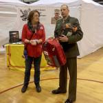 Laurie Finlayson donated an AED with a portable backpack to Major Ken Paul, the JROTC instructor at Kentwood High School in March 2017. The Nick of Time Foundation also screened 293 students at this event, and found three people with heart issues that needed follow-up care. Submitted photo.