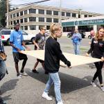Carrying Enumclaws Youth Centers new backdoor is Scott Karanja and Christian Sprague in the back, and Olivia Robbins and Ava Jenkins in the front. In the background, Sue Z. Hart takes photos. PHOTO BY RAY MILLER-STILL