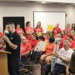 Jim Payette, at the podium, was joined by dozens of teachers, classified staff members, and community members of the Sumner-Bonney Lake School District on Aug. 15, who all packed the school board meeting to advocate for pay raises. Photo by Ray Miller-Still