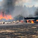 Brush fire burns 12 acres, several buildings and vehicles