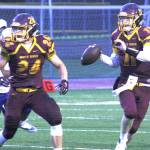 White River quarterback TJ Strochein looks for a receiver during Fridays victory while Jack Ervien looks to provide some protection. KEVIN HANSON PHOTO