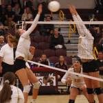 Sumner sophomore Jordyn Manning goes for the kill, while Hornet Lauren Hanson attempts to block. Photo by Kevin Hanson