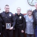 From left to right, Teri Moore, Officer Ryan Keller, Police Chief Jamey Kiblinger, Mayor Carol Benson, and Joe Moore after Keller was given the Life Saving Award. Photo by Ray Still