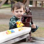 Elijah Cunningham races rubber ducks at Thomasson Family farms. File photo Ray Miller-Still