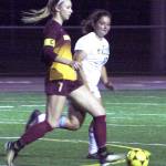 White River senior Choe Narolski and her Hornet teammates opened West Central District play this week. Above, Narolski races past a Foss defender during the Hornets regular season finale. Photo by Kevin Hanson