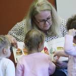 Catherine OBrien, youth services librarian, keeps kids attention during a fall session of Family Story Time at the Bonney Lake library. The hour-long program also included games and interactive play with a colorful parachute. File image by Kevin Hanson