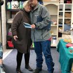 Kevin Booth hugs Anita Hill after being presented with a citizens citation for giving the Sumner Food Bank the $17,000 he found. Submitted photo
