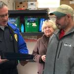 Sumner Police Chief Brad Moericke gives Kevin Booth a citizens citation for giving $17,000 to the Sumner Food Bank. Submitted photo
