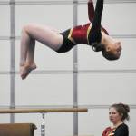 White River senior Annelyse Anderson flips from the bean during her dismount. Photo by Kevin Hanson
