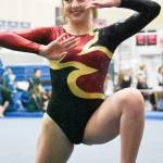 Enumclaw senior Payton Mapes strikes a pose during her floor routine. White River senior Annelyse Anderson flips from the beam during her dismount. Photos by Kevin Hanson