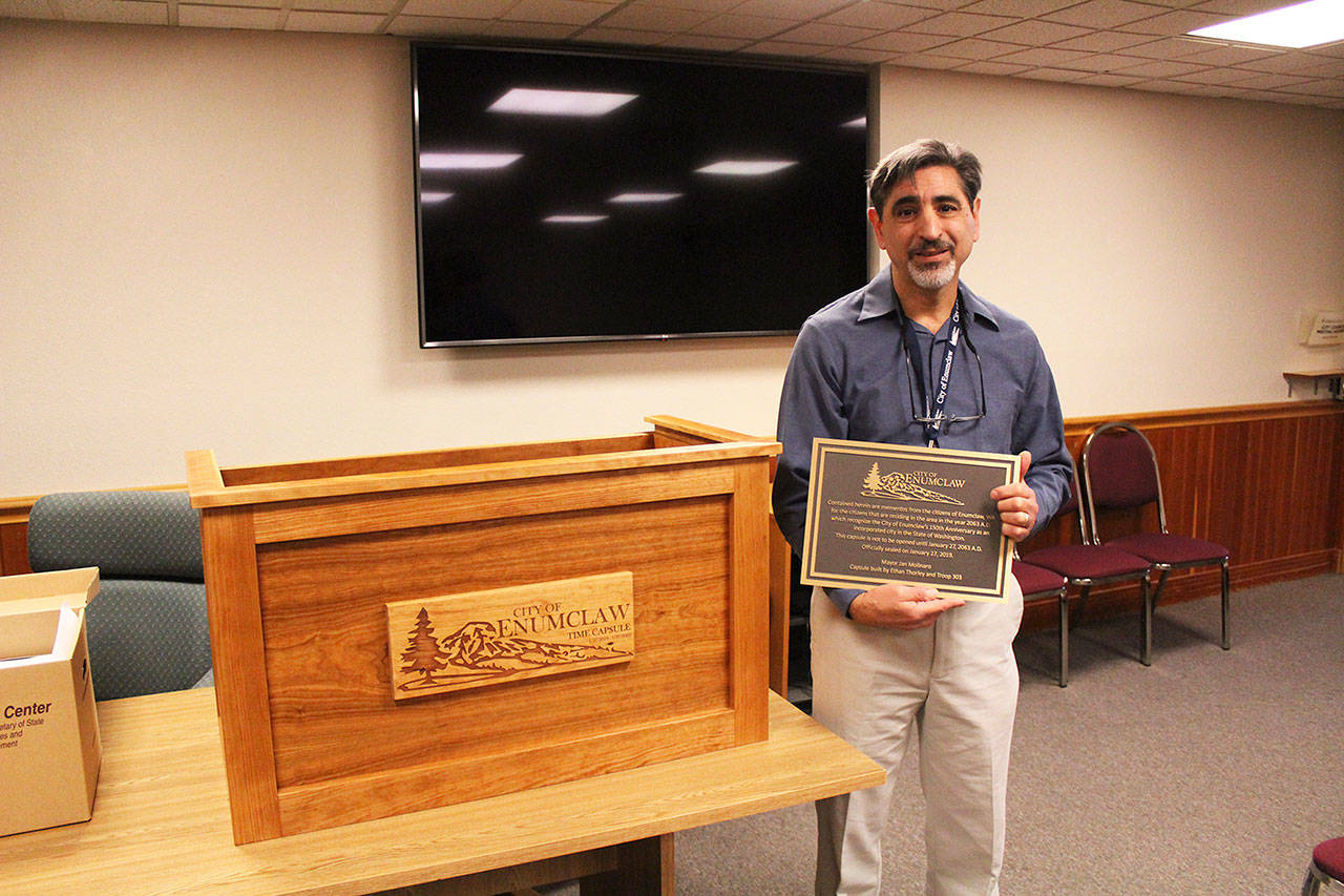 Jan Molinaro stands next to Enumclaws newest time capsule, which was created by local student and boy scout Ethan Thorley and other members of Troop 303, Nathan Erickson, Chad Jimenez, and Steven Reindeau. Photo by Ray Miller-Still