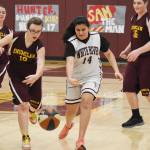 Enumclaw and White River programs got together again this year for an evening of Unified Special Olympics basketball, unrelated to their schools postseason. A game was first played in Buckley and then, a week later on Jan. 30, in the EHS gymnasium. Here, Enumclaws Desiree Peterson scrambles for a loose ball, along with White River peer tutor Rashida Badri, an exchange student from Morocco. Also pictured are Enumclaws Danny Martin (16) and Delaney Murphy (7) and White River peer tutor Tyson Campbell (15). Photo by Kevin Hanson